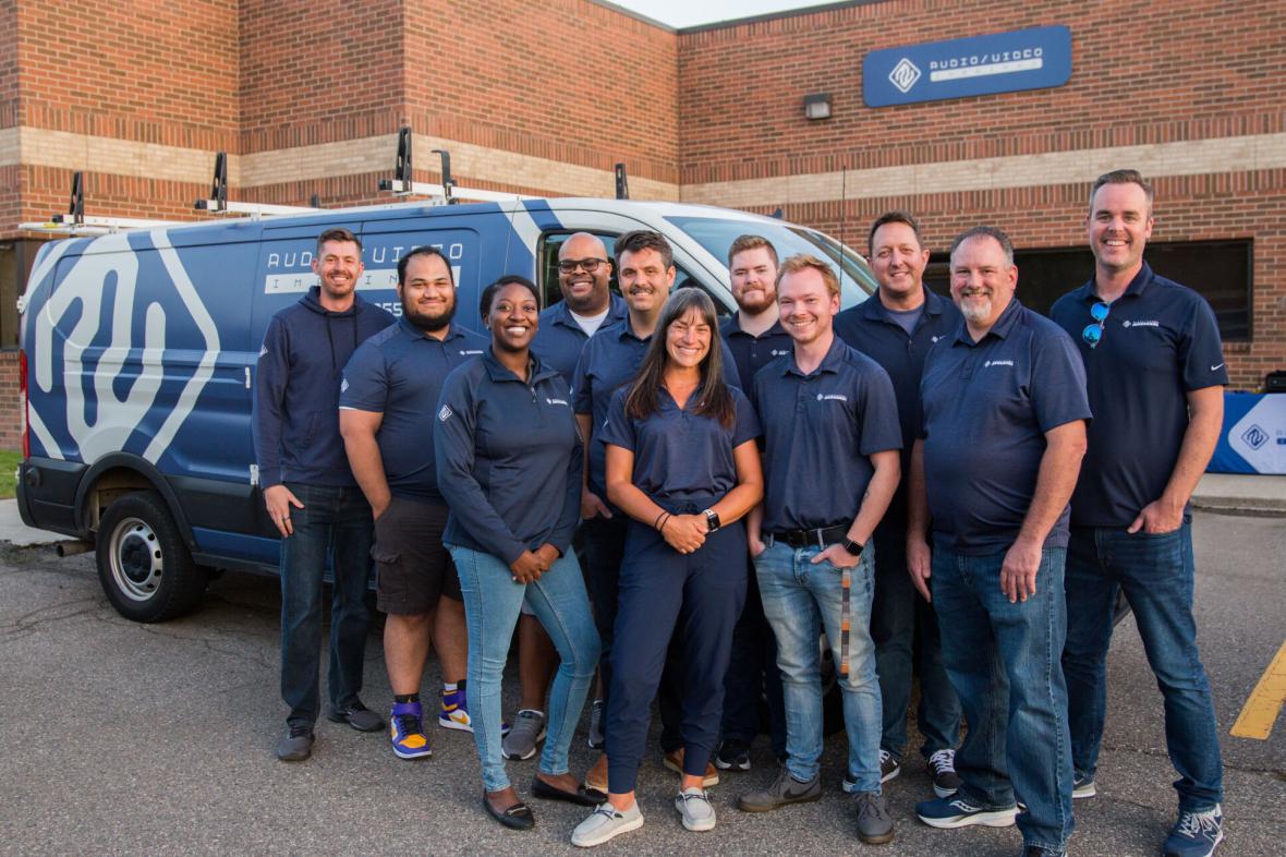 AV Imagined team standing outside in front of company vehicle